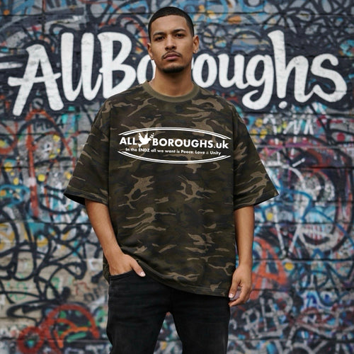 Person wearing a camouflage t-shirt with 'All Boroughs.uk' logo in front of a graffiti-covered wall. Also known as All Boroughs.