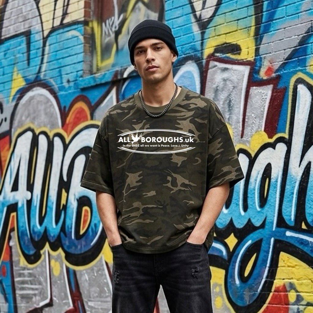 Person wearing a camouflage t-shirt with 'All Boroughs UK' text in front of a colorful graffiti wall. Also known as All Boroughs.