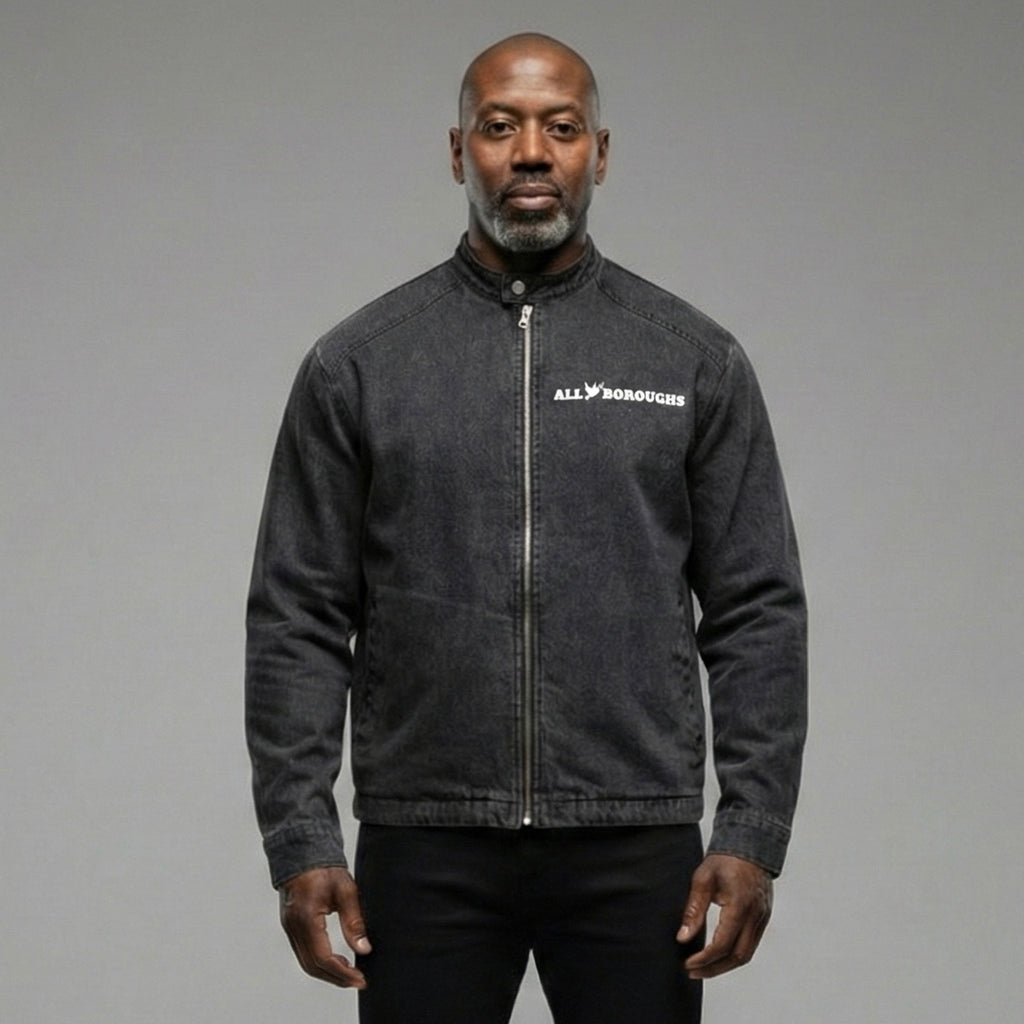 Man wearing a dark gray jacket with an All Boroughs logo on a gray background