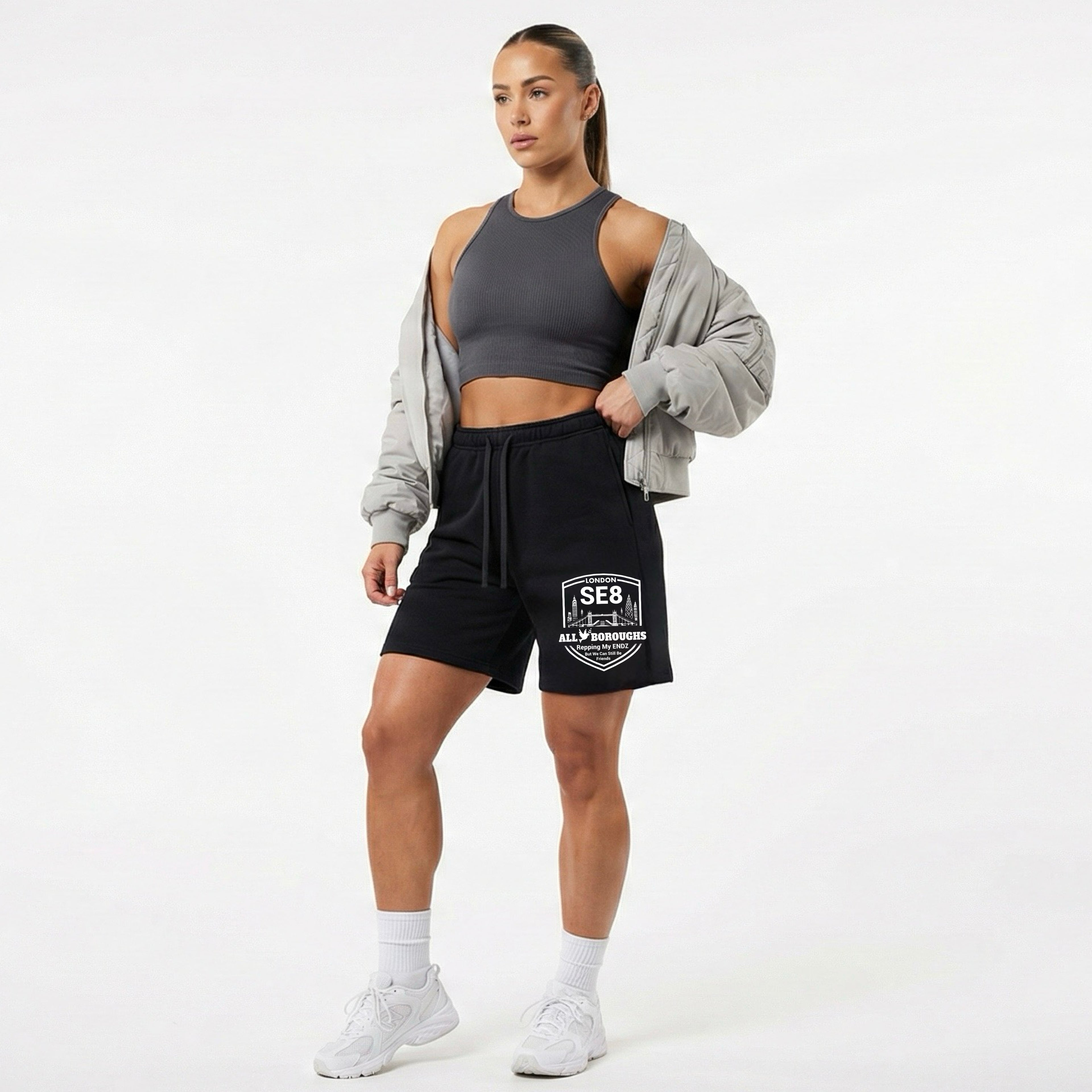 Woman wearing black shorts with an AllBoroughs brand logo on a white background