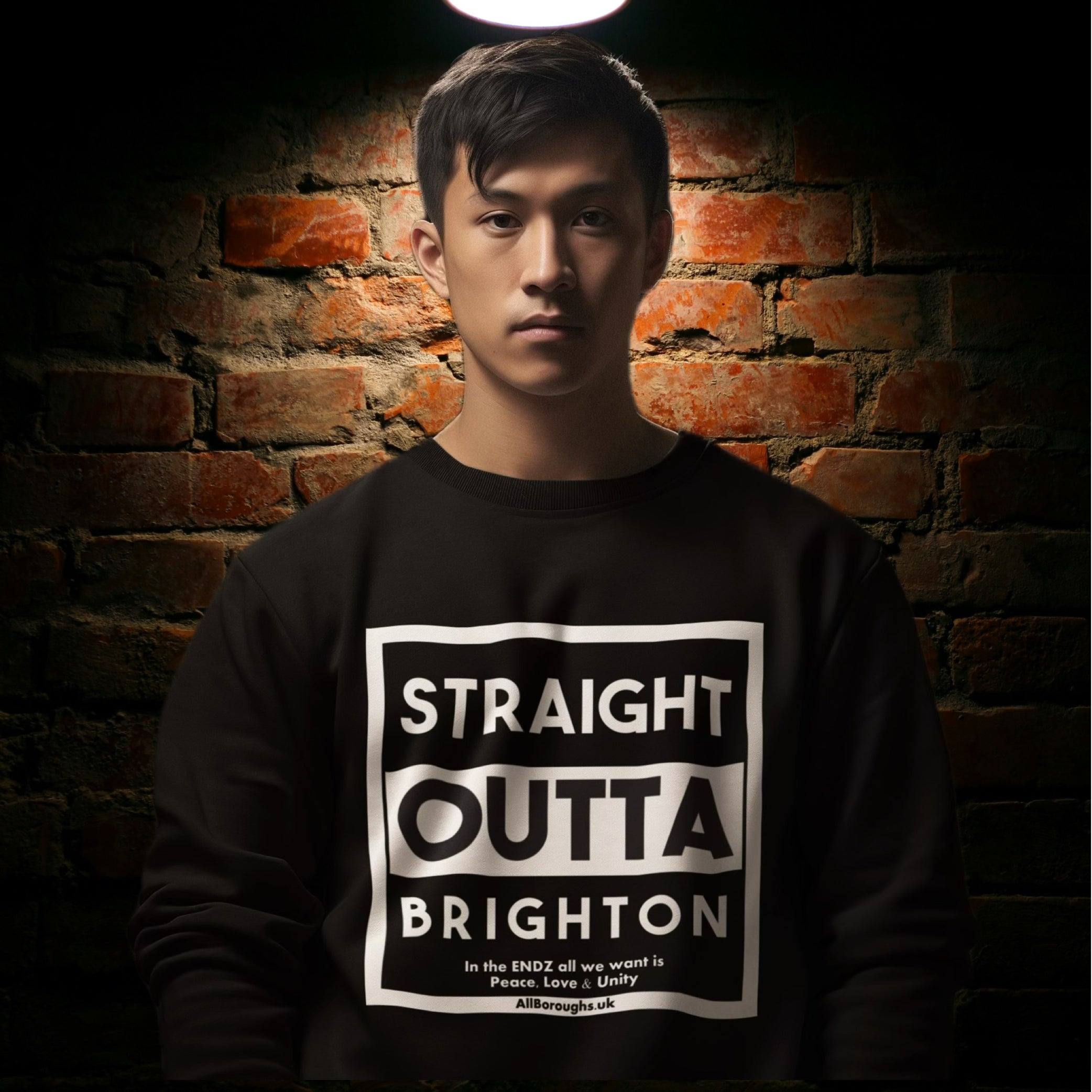 Person wearing a black All Boroughs sweatshirt with 'Straight Outta Brighton' text against a brick wall.