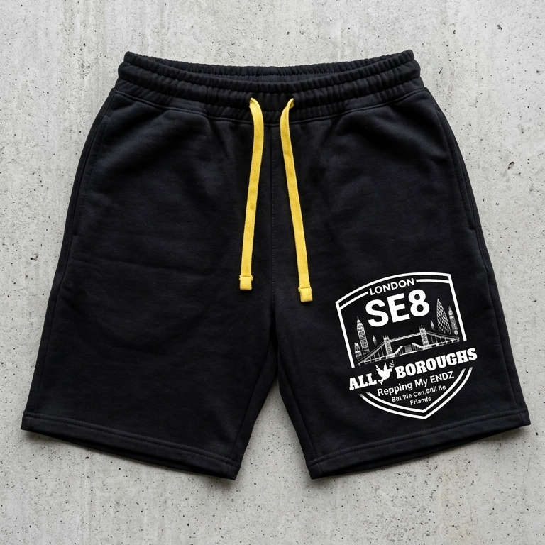 Black ALLBOROUGHS shorts with yellow drawstring on a concrete surface