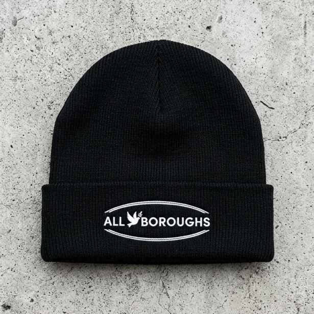 Black beanie with 'All Boroughs' logo on a gray concrete surface
