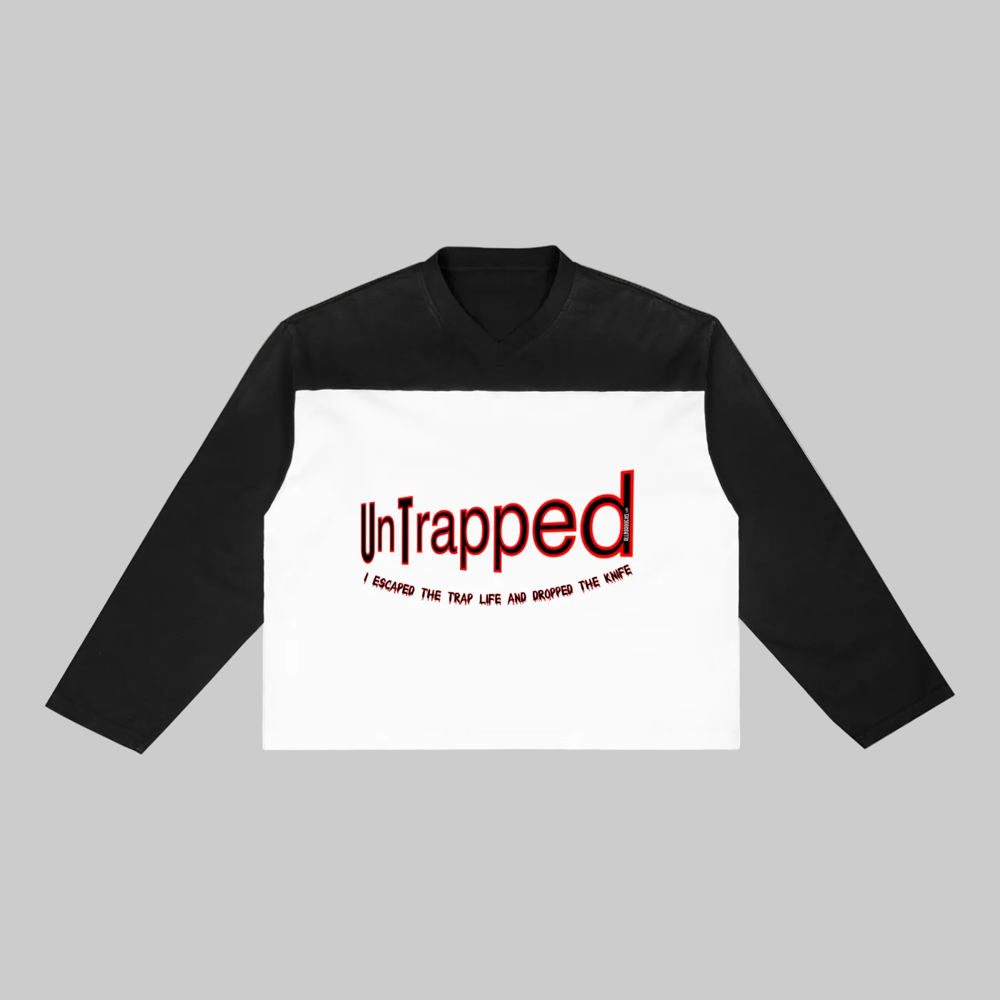Black and white long-sleeve shirt with 'Untrapped' text on a white background