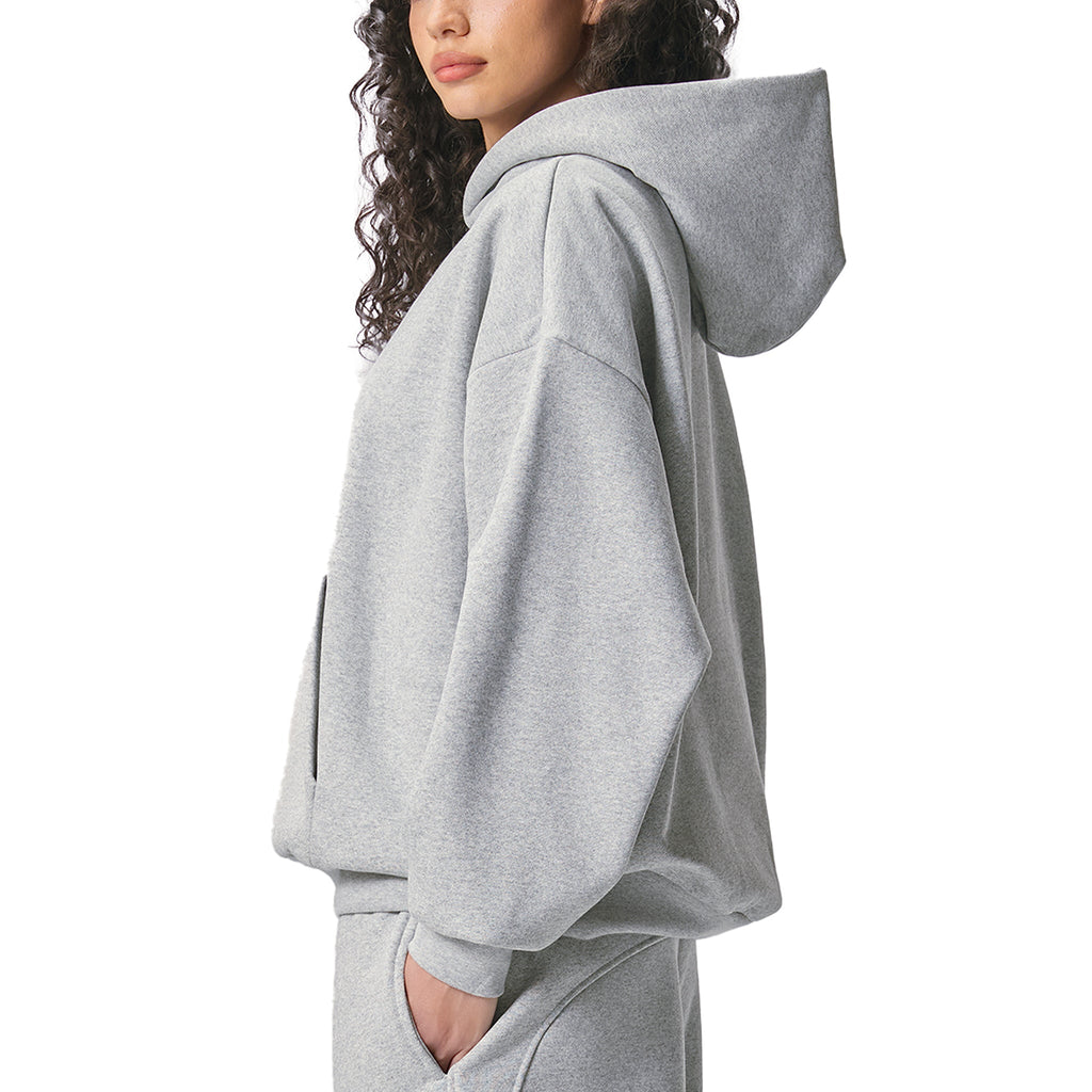 Person wearing a grey AllBoroughs hoodie and pants on a white background